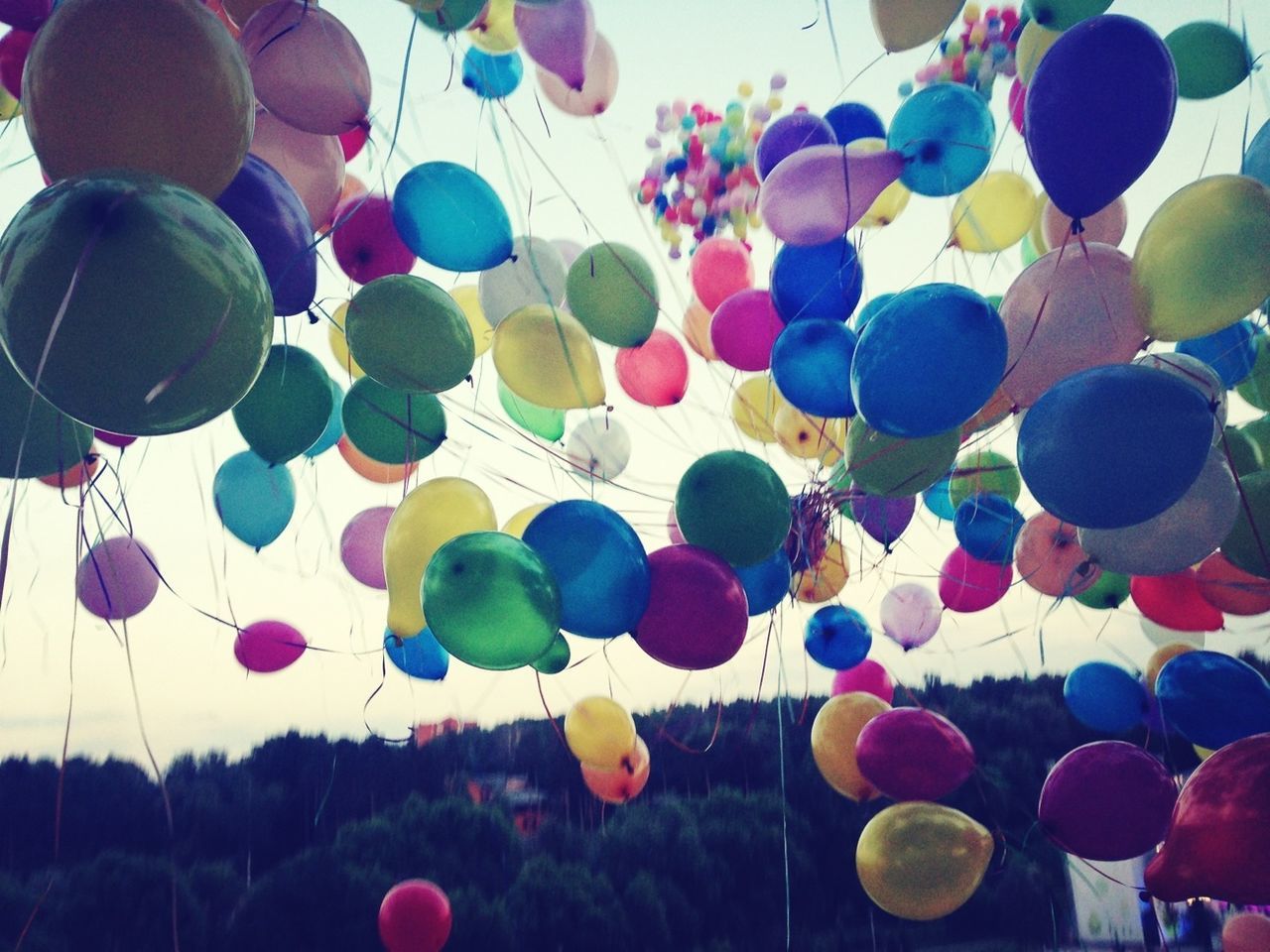 multi colored, balloon, low angle view, sky, celebration, in a row, hanging, variation, abundance, decoration, hot air balloon, colorful, large group of objects, lighting equipment, blue, mid-air, no people, outdoors, sphere, nature