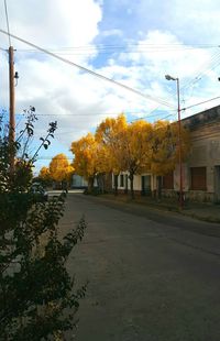 Empty road with buildings in background