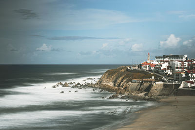 Scenic view of beach by sea against sky