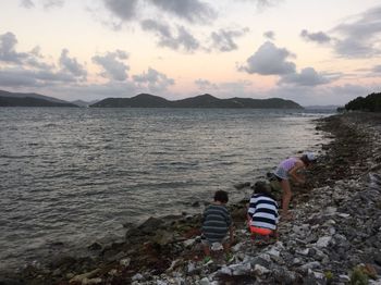 Rear view of father with son on beach