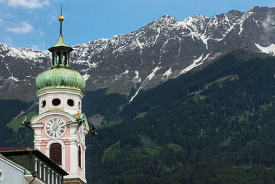 Traditional building by mountains against sky