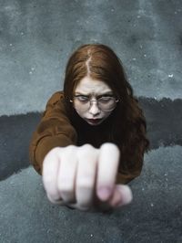 Close-up portrait of young woman standing on road