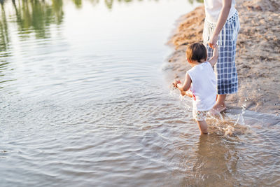 Mother and daughter walking on the beach.