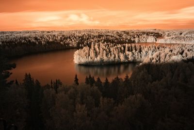 Scenic view of landscape against orange sky