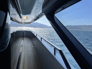 Low angle view of ship sailing in sea against sky