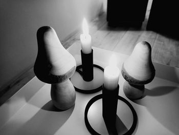 High angle view of lit candle on table