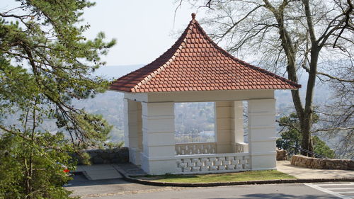 Exterior of house on field by building against sky