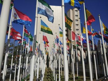 Low angle view of flags hanging against sky