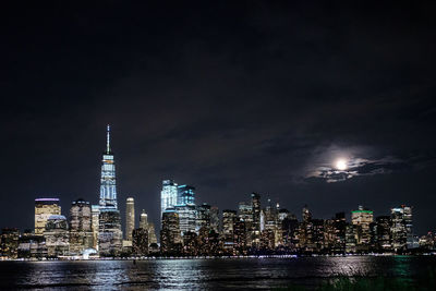 Illuminated buildings against sky at night