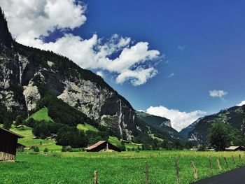 Scenic view of mountains against cloudy sky