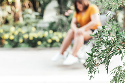 Woman sitting on a tree