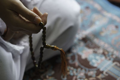 Close-up of hand holding chain