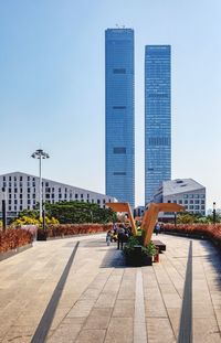 Modern buildings in city against clear blue sky