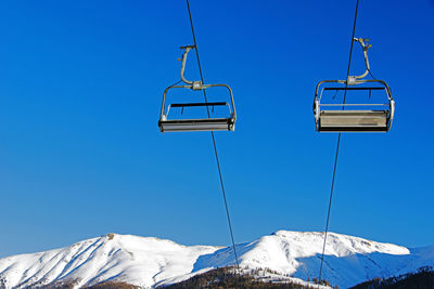 Ski lifts and cars in the blue sky in the alps switzerland