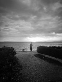 Man looking at sea against sky