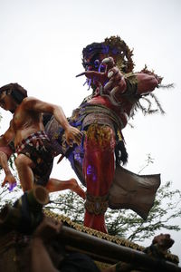 Low angle view of statue against sky