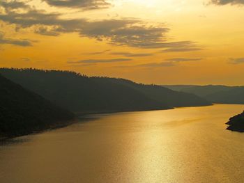 Scenic view of lake against sky during sunset