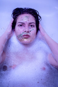 Portrait of shirtless boy in water