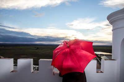 Red umbrella against sky