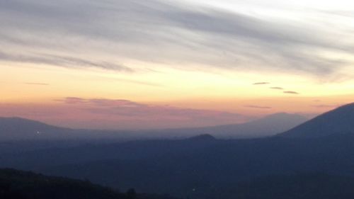 Scenic view of silhouette mountains against sky at sunset