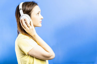 Low angle view of woman against blue sky