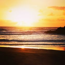 Scenic view of beach against sky during sunset