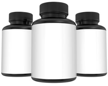 Close-up of pill bottles against white background