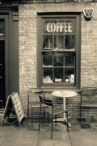 Chairs against brick wall