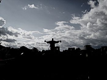 Low angle view of silhouette building against sky