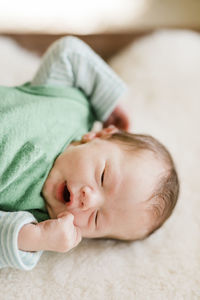 Cute baby girl lying on bed