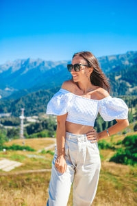 Young woman wearing sunglasses standing outdoors