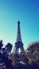 Low angle view of eiffel tower against blue sky