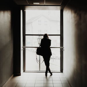 Full length of woman standing by railing