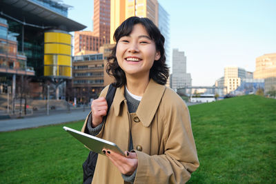 Portrait of young woman using mobile phone