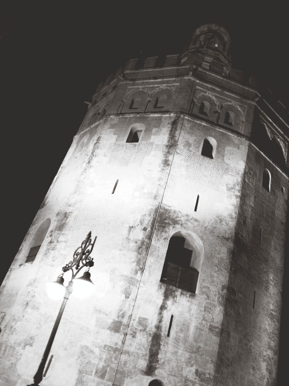 architecture, built structure, building exterior, low angle view, old, history, night, clear sky, church, building, religion, window, arch, tower, place of worship, sky, outdoors, no people, historic