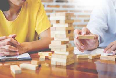 Close-up of people working on table