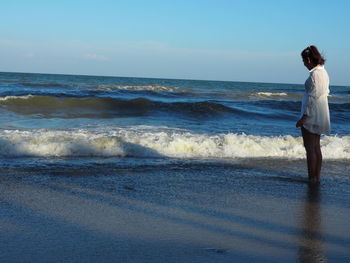 Woman standing on beach
