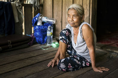 A single indigenous woman sitting and smiling