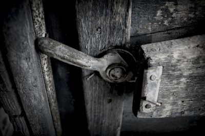 Close-up of padlock on wooden door