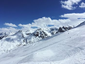 Scenic view of snow covered mountains against sky