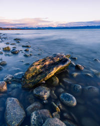 Aerial view of rocks in sea against sky