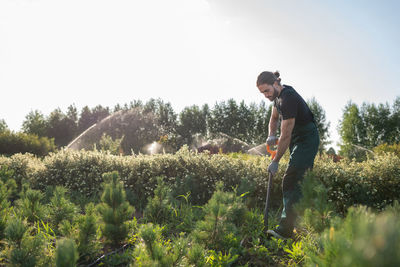 Male farmer digging soil in garden