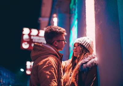 Young couple standing at night