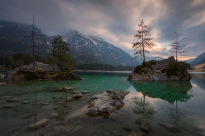 Scenic turquoise lake against sky during sunset