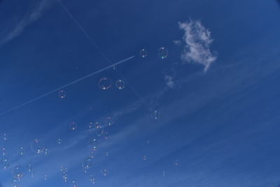 Low angle view of vapor trails in sky