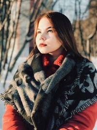 Close-up of woman standing in forest during winter