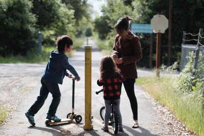 Woman and two children on footpath