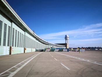 Road by building against sky