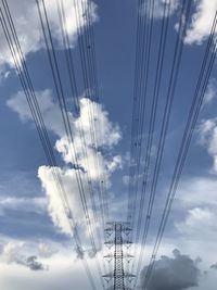 Low angle view of electricity pylon against sky