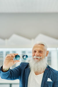 Portrait of man holding camera